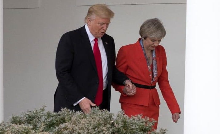 Donald Trump Theresa May holding hands