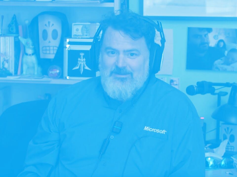 Tim Schafer Microsoft shirt listening to actual Zune